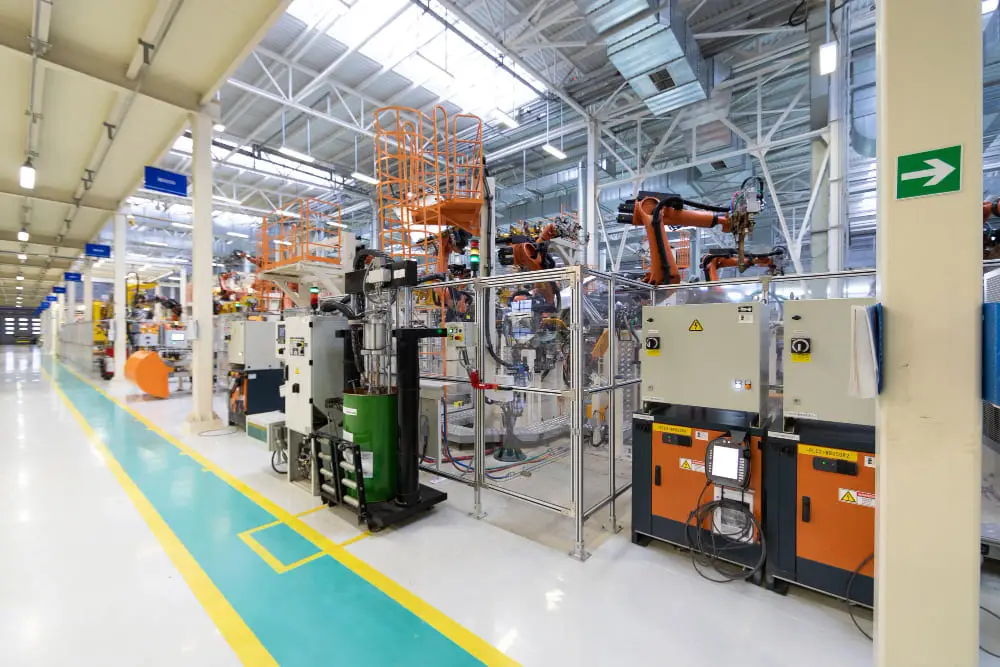 View of a modern, high-tech manufacturing facility showing cages with robotic arms